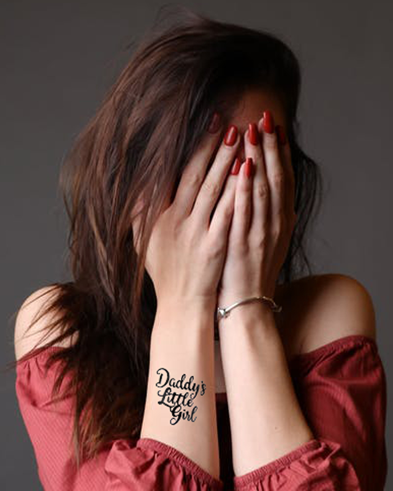 in this picture you can see a girl who cover her face with both hand and you can also see a Tattoo on her right hand. This Tattoo design by the best Tattoo artist in Jhansi.